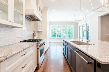 white granite countertop with white and brown cabinets