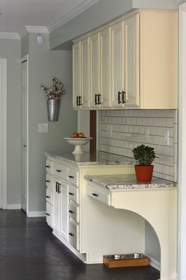 white granite countertop in kitchen corner with white cabinets