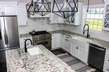 white granite countertop in black and white modern kitchen