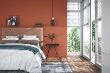 bedroom with copper wall and large windows