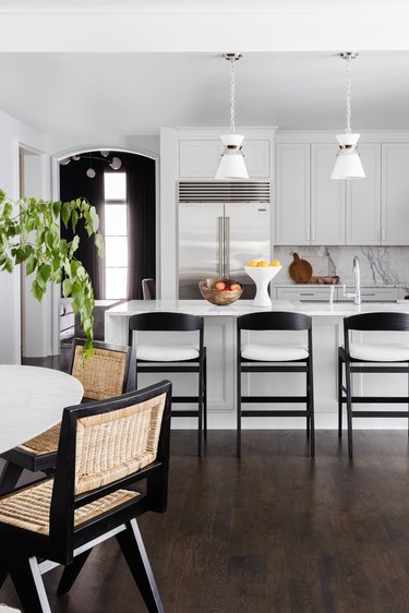 white kitchen with light gray cabinets and black counter stools