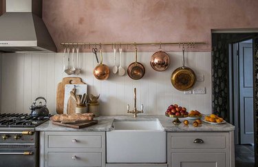 rustic neutral kitchen with pink wall and gray cabinets