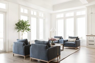 Navy blue chairs against light hardwood floors with white walls