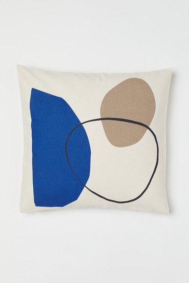 cushion cover in blue, black, and beige graphic pattern