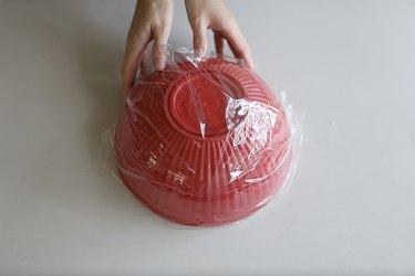 Covering large bowl with plastic wrap