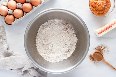 A metal bowl filled with the dry ingredients.