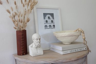 DIY paper mache bowl on top of books styled on a table