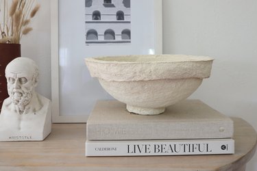 DIY paper mache bowl on top of books