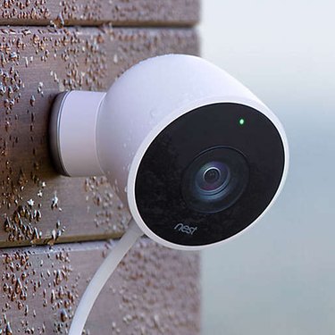 A Google nest camera is on the side of a house