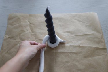 Wrapping clay snake around black spiral taper candle