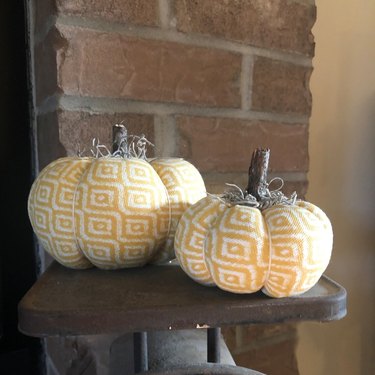 two fabric pumpkins in a yellow pattern
