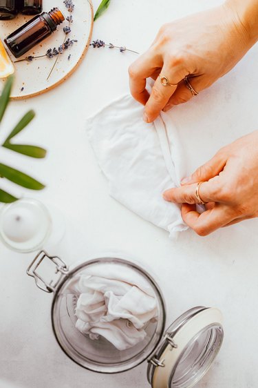 Roll up reusable dusting cloths and store in a jar with a lid