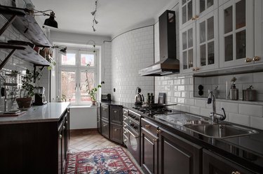 kitchen with black cabinets and saltillo tile