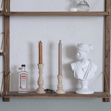 wooden candlesticks on shelf