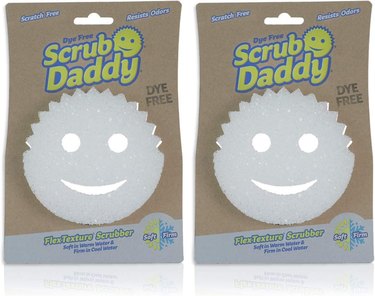 Two packages of white Scrub Daddy smiley face sponges.