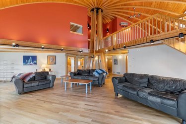 Interior of a dome-shaped house with arched ceilings and leather couches