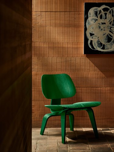 An emerald green Eames wood lounge chair.