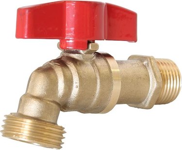 A brass ball-valve faucet with a red knob