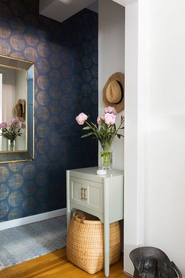 sage green furniture with navy blue walls
