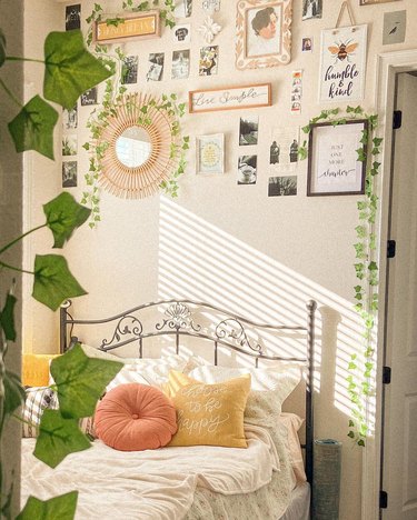 bedroom with colorful throw pillows and hanging vines