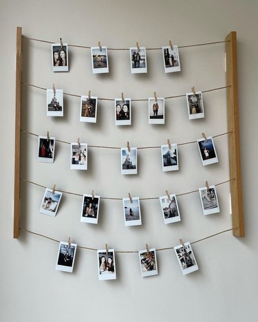 polaroid display with photos clipped to horizontal wires