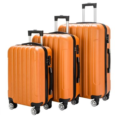 Set of three orange suitcases