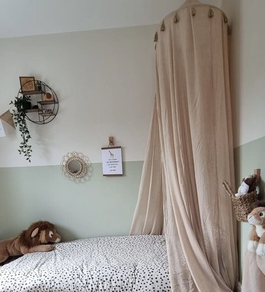 bedroom with peach canopy and pale green lower walls