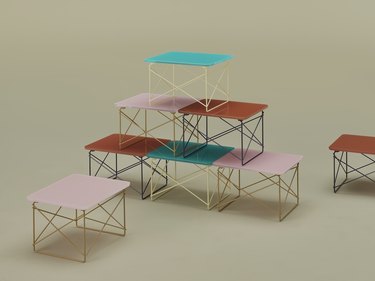Side tables with wire legs stacked on top of each other in the colors teal, light pink, and burnt orange.