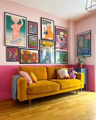 retro pink living room with mustard yellow couch and gallery wall