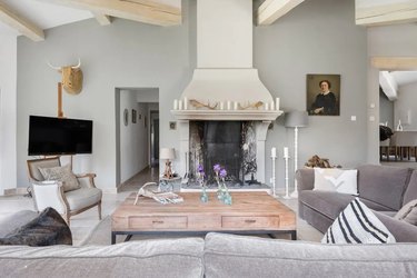 french country living room with gray walls and fireplace