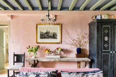 french country living room with pink chalk paint walls