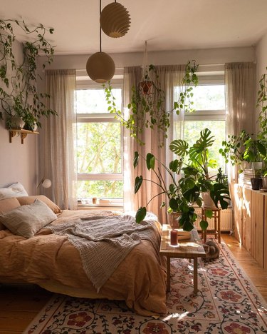 bedroom with neutral colors and lots of plants