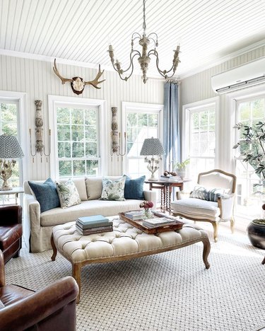 light filled french country living room with tufted coffee table