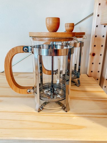 French press with glass carafe and wooden handle and lid