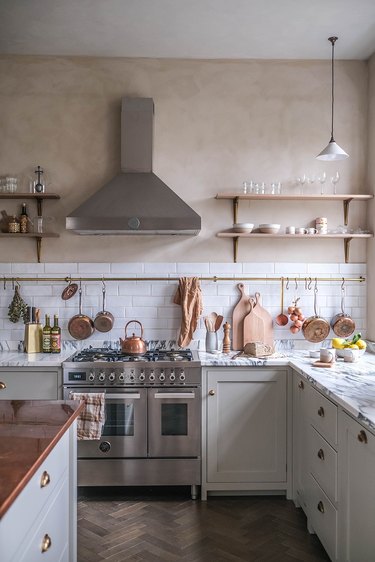 warm plaster kitchen walls with brass and copper accents