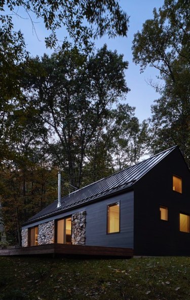 Black modern farmhouse with metal roof.