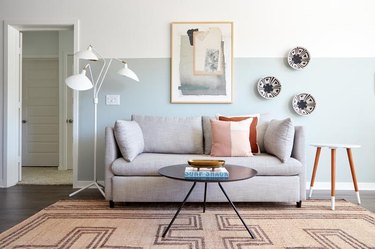 modern living room with half painted light blue wall
