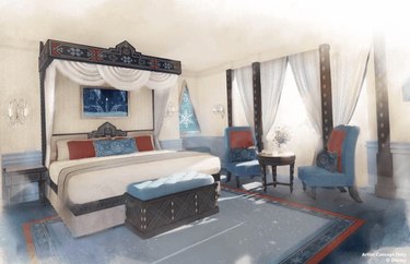 Mock of a new room in the Disneyland Paris hotel with Frozen-themed accents like snowflakes on the carpet, a white bed with a canopy, and blue chairs with red pillows.