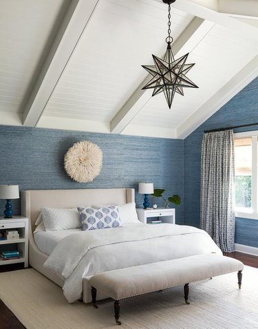 bedroom with blue grasscloth wallpaper and ivory accents