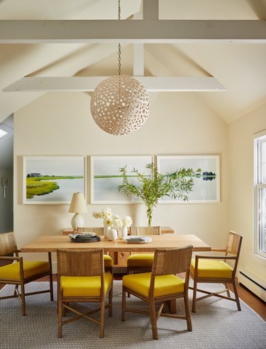 dining room with yellow chairs and ivory painted walls
