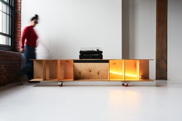 blurry image of person moving near a console with lights