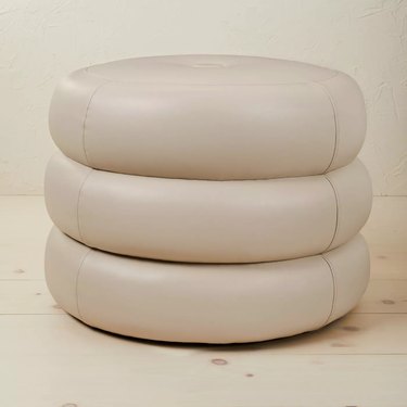 faux leather pouf in off-white color