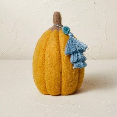 felted pumpkin figure with blue tassel