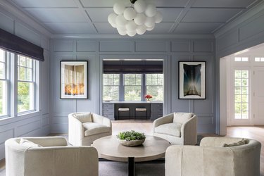 periwinkle living room with ivory furniture and chandelier