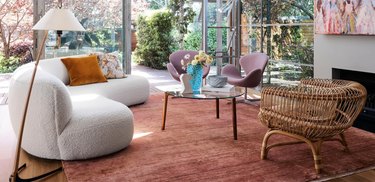 living room with garnet rug, a pair of lilac chairs and ivory sofa