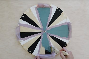 Painting teal chalkboard paint on IKEA kids activity wheel