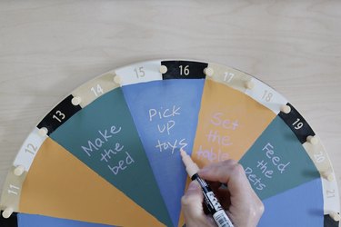 Writing kids' chores on painted IKEA activity wheel