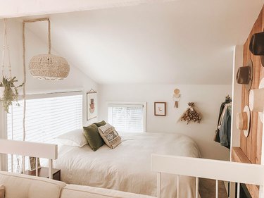 neutral boho studio apartment bedroom with macrame hanging light