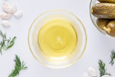 A small glass bowl filled with olive oil and white vinegar together.