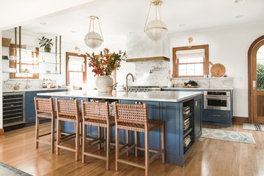 White kitchen with navy cabinets.